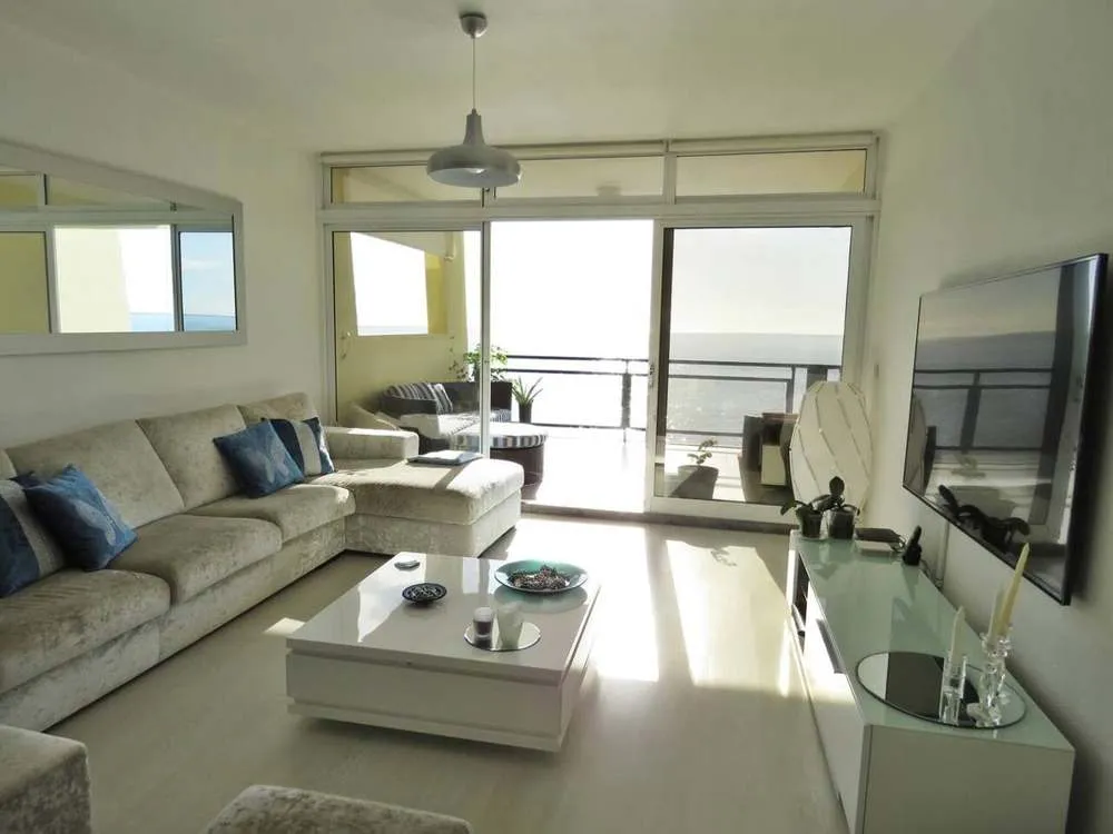 The bright and modern living room with LCD TV.