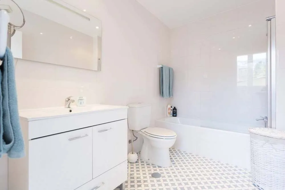 First bathroom with shower and bath.