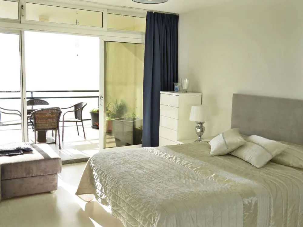 The master bedroom opens out onto the balcony.