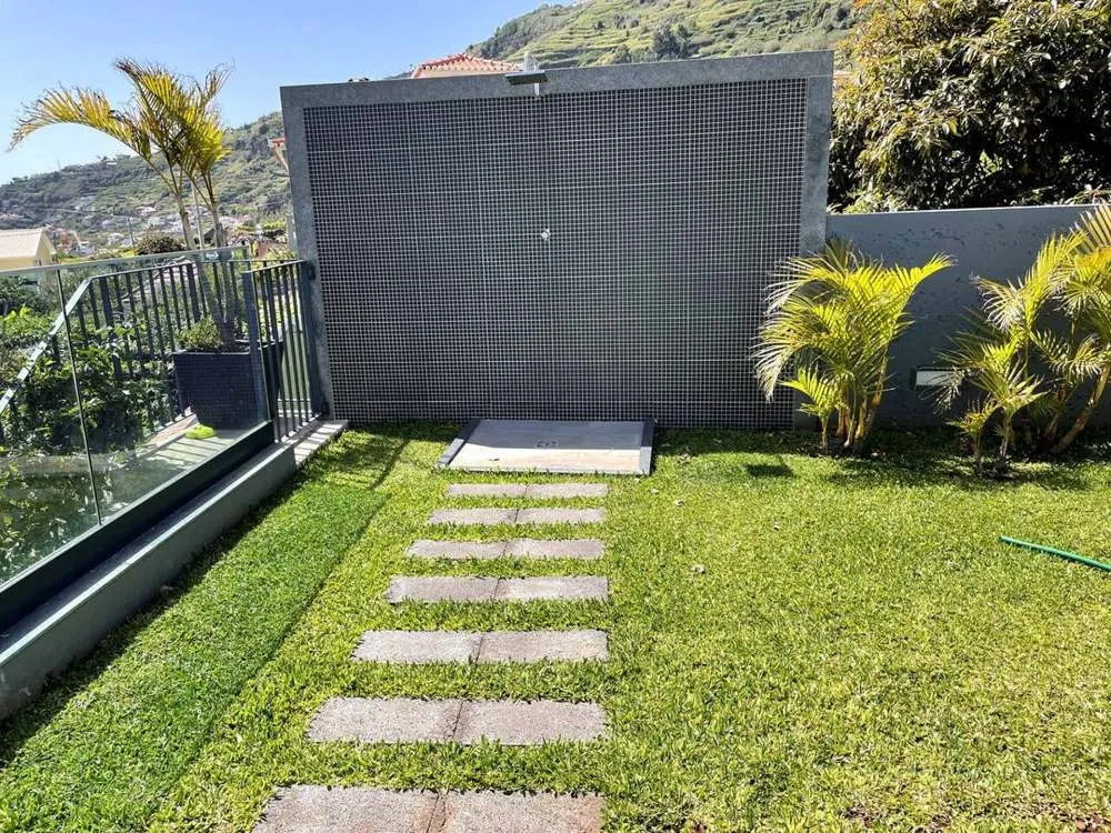 Outdoor shower surrounded by mountain and sea views.