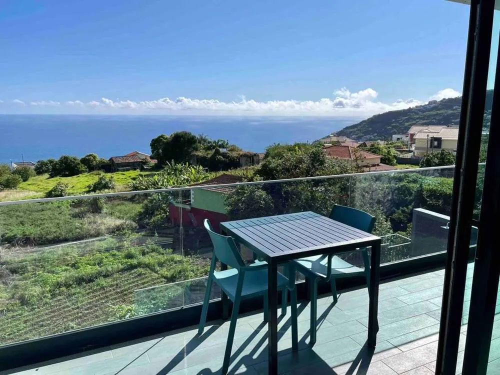 Infinite sea and mountain views from the small dining table on the upstairs balcony. Perfect for a morning coffee.