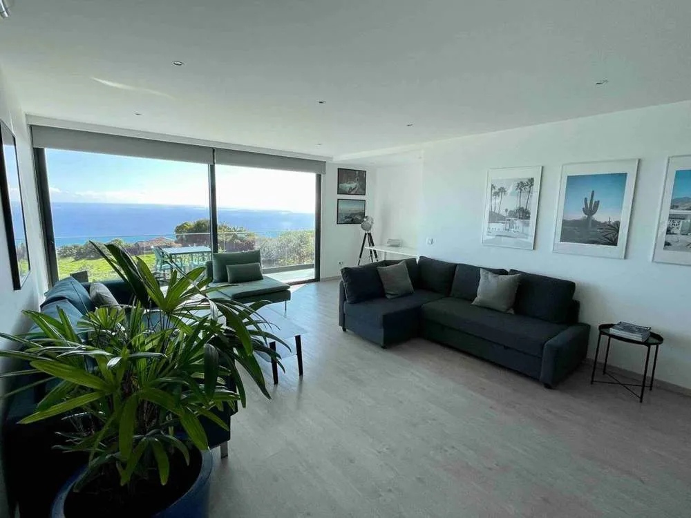 The upstairs lounge, perfect to connect with friends and family, equipped with a dedicated workspace, AC, sleeper couch and leading on to the upstairs balcony.
