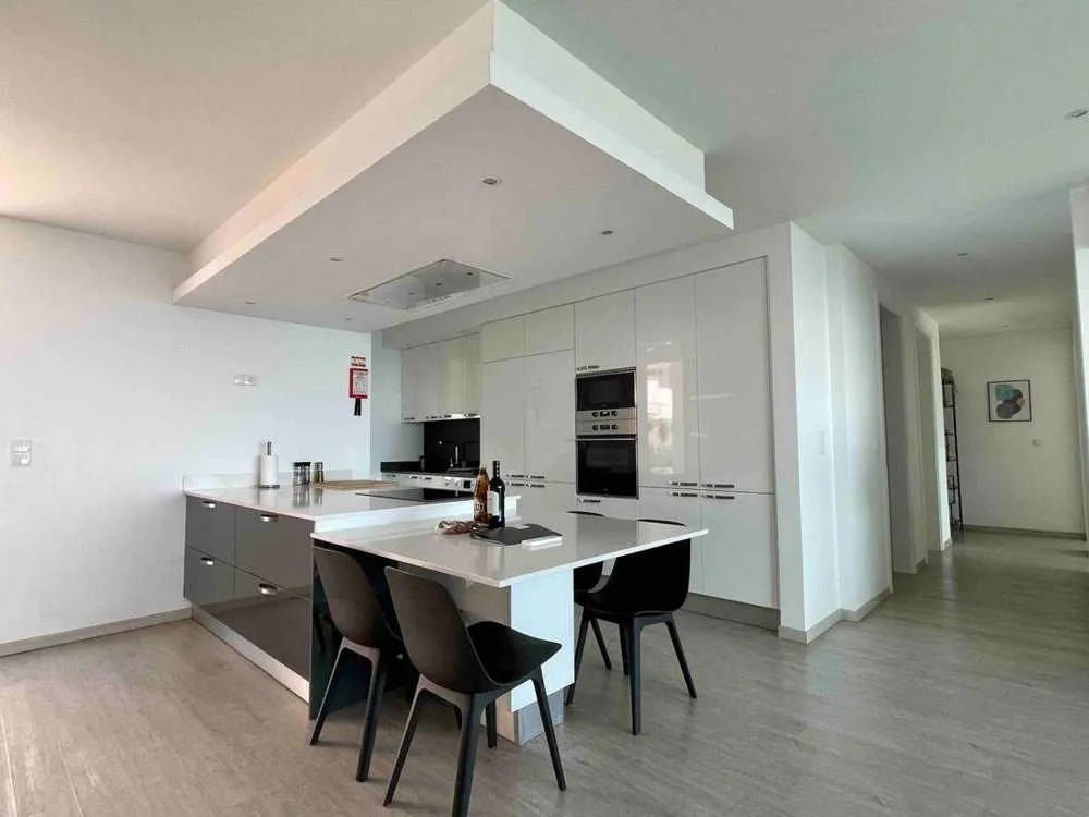 A fully equipped upstairs kitchen and dining area including a large stove, oven, microwave, blender, coffee machine, toaster, dishwasher, washing machine and drier.