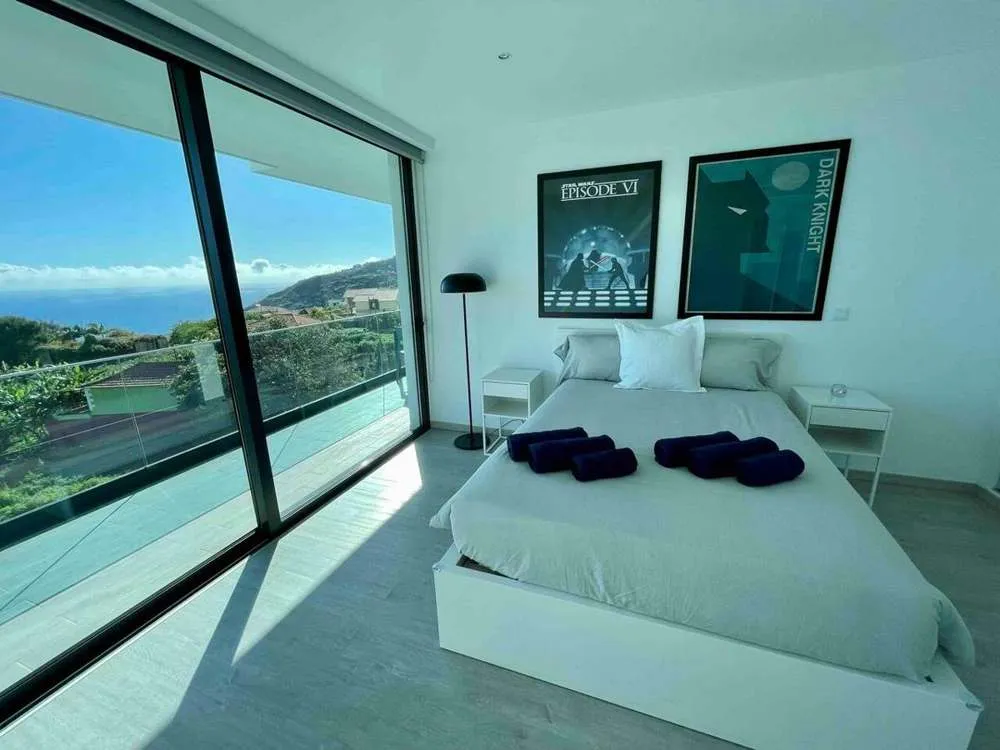 The double bedroom with build in closets and stunning sea and mountain views that lead on to the upstairs balcony.